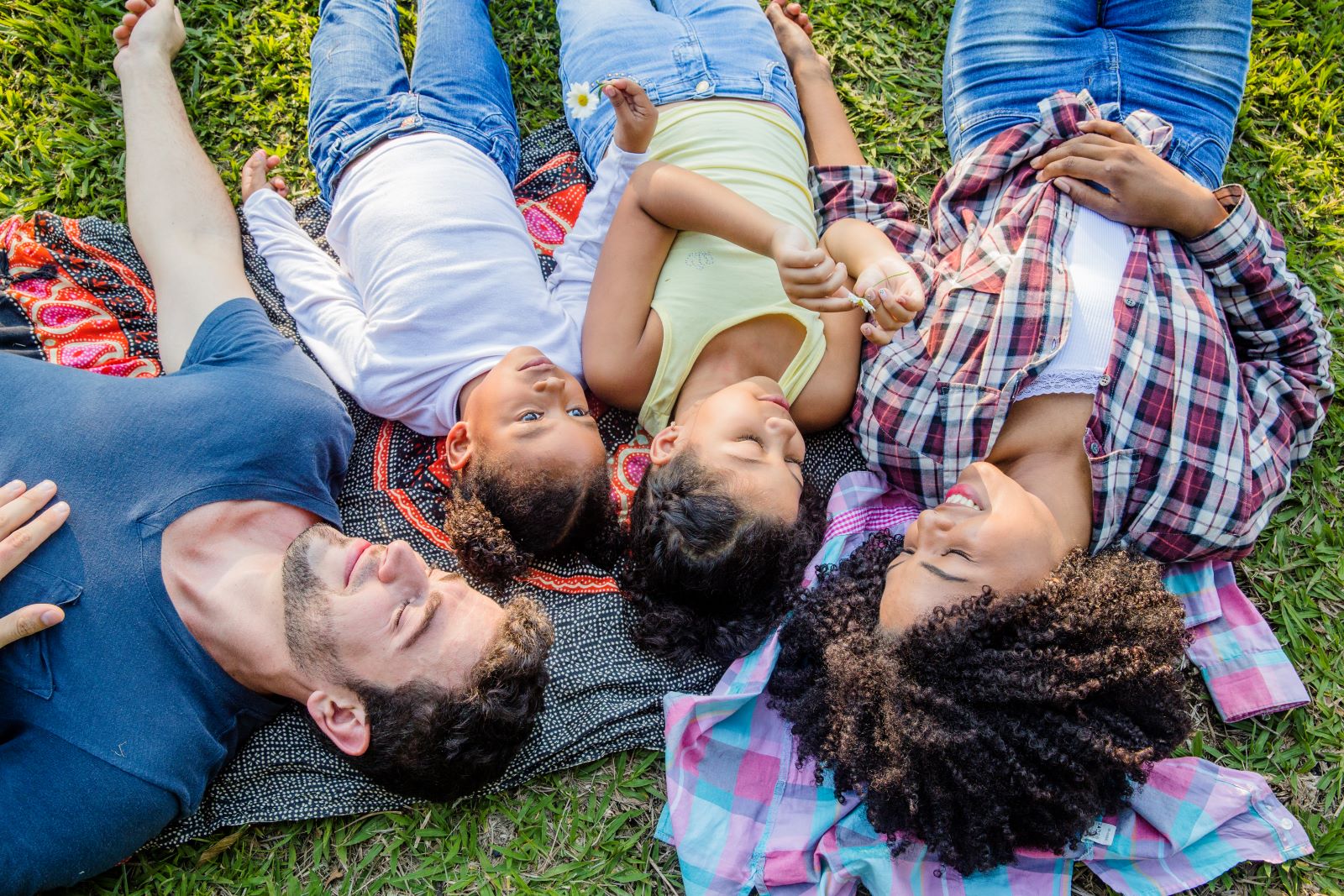 people lying on the grass